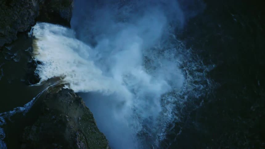 Looking straight down on the 200 foot high Palouse Falls in blue hour light as is cascades to the pool below in spring flows