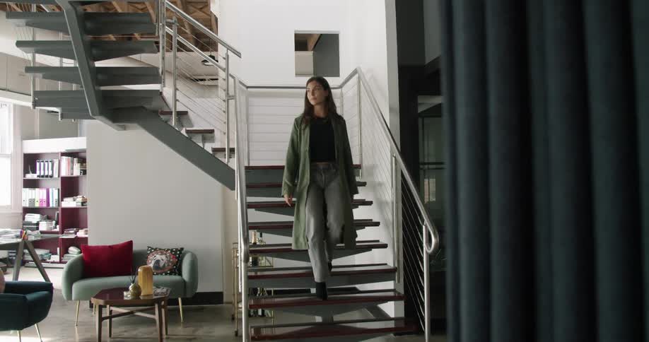 Woman walking down the stairs on a modern office space