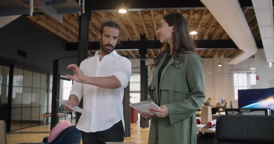 Boss instructing employee in a modern office space