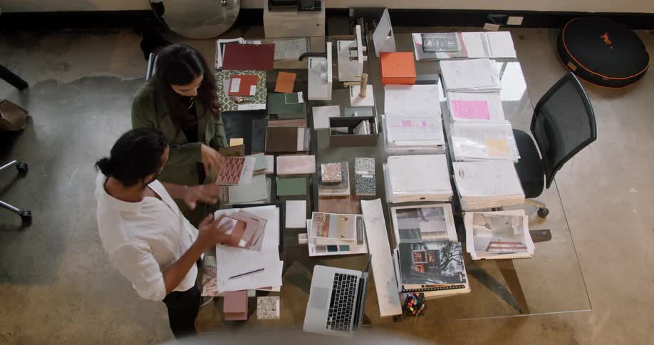 A man and woman are in an office together and talking