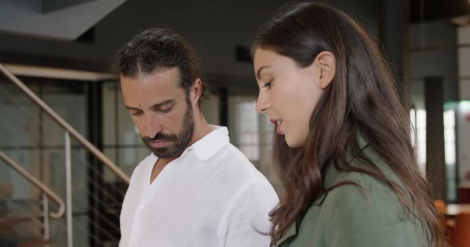 A man and woman looking at samples in an office
