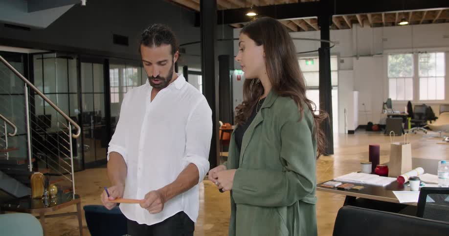 A man and woman talk in the office