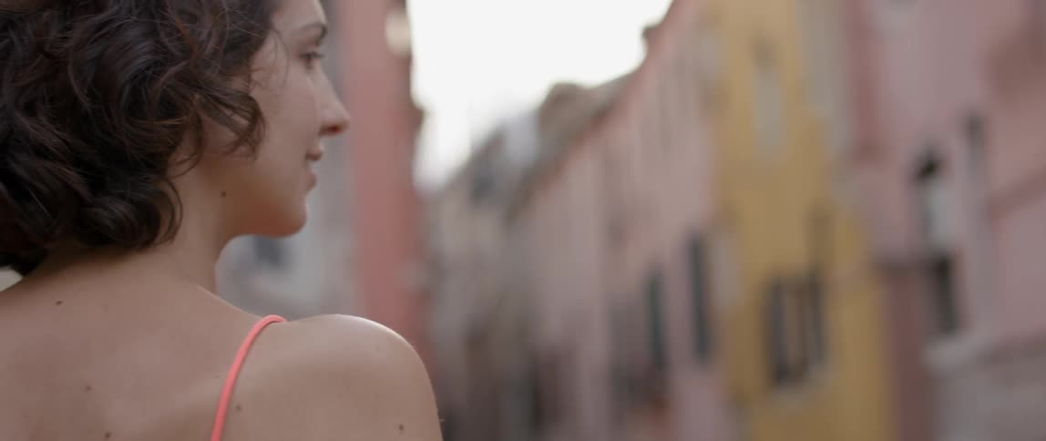 A woman is looking around on a cloudy day