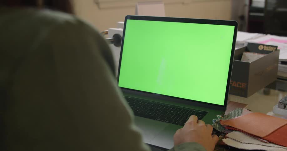 A person using a laptop at a desk