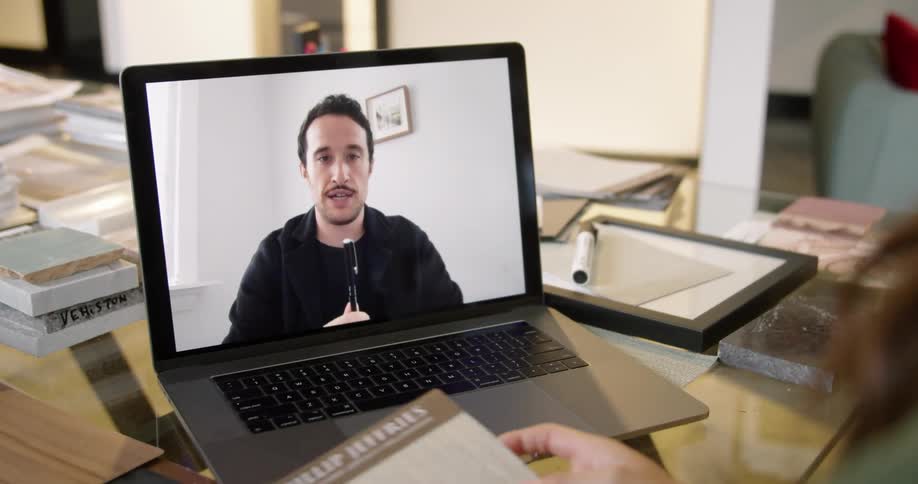 Male and female office workers have meeting via laptop