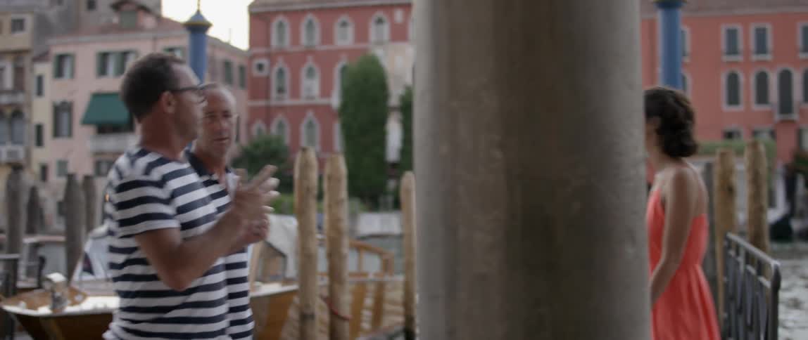 A woman walks along a dock in venice, italy