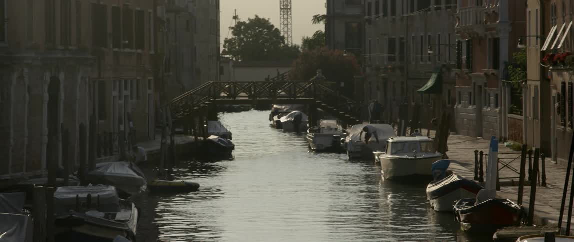 A small canal is in between rows of buildings