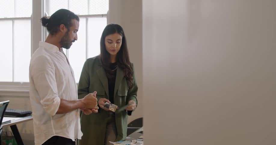 Man and woman looking at samples and talking in the office