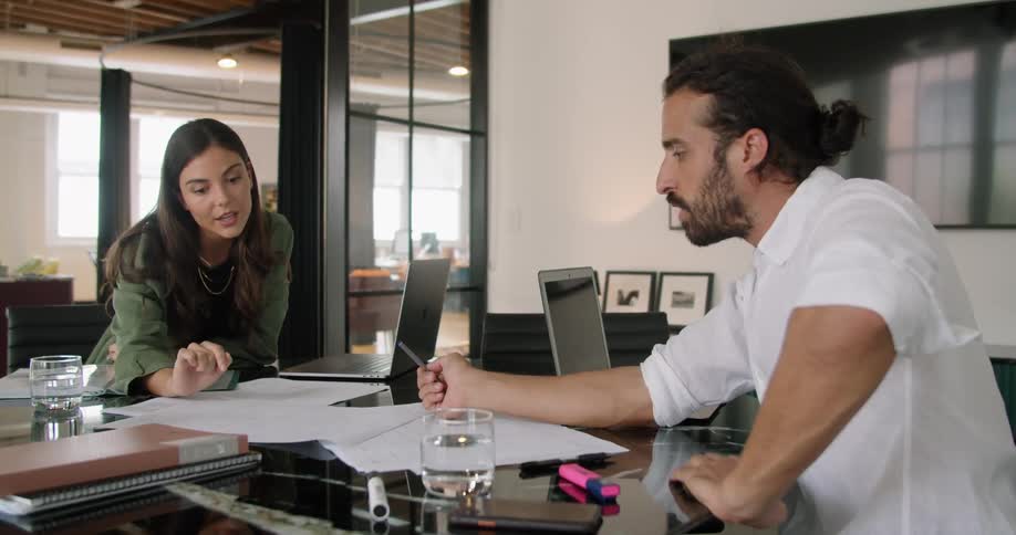 Two people having an amiable meeting in the office at daytime