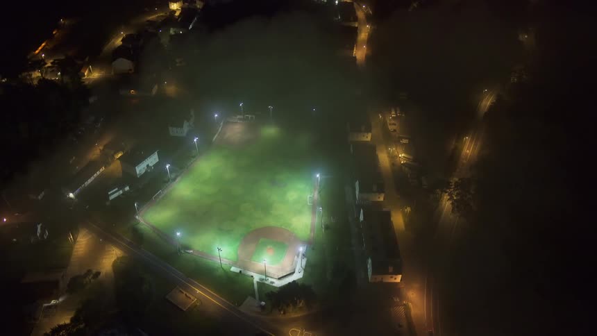 Aerial of a lit up baseball field at night