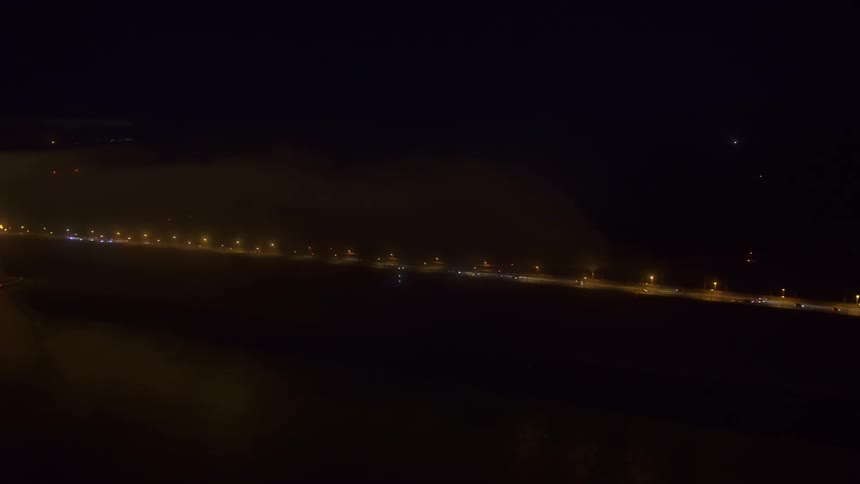 An aerial view of a bridge at a city at night