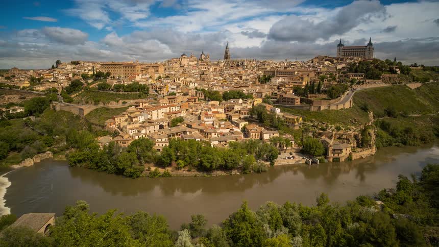 Timelapse of the castles and towers on a small town near a river at daytime