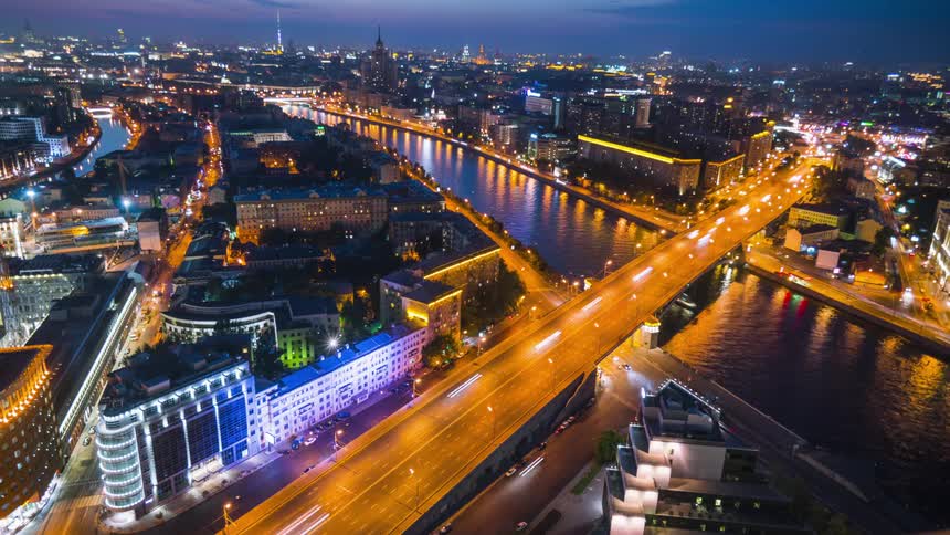 Time lapse of traffic flowing over a river on the city downtown at night