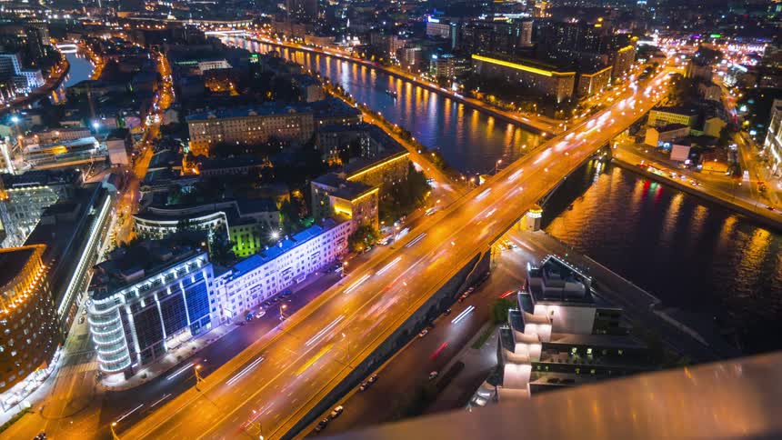 A city with rivers and bridges with buildings streets and vehicles