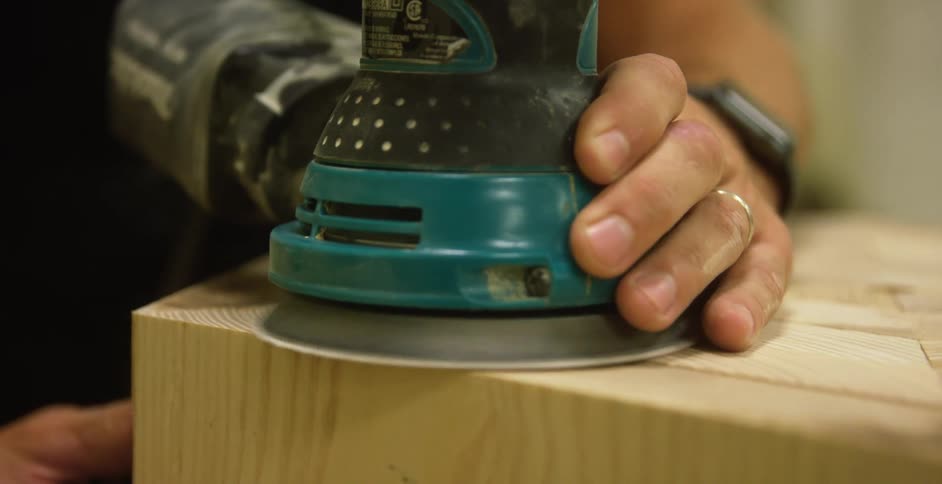 Closeup of person sanding wood