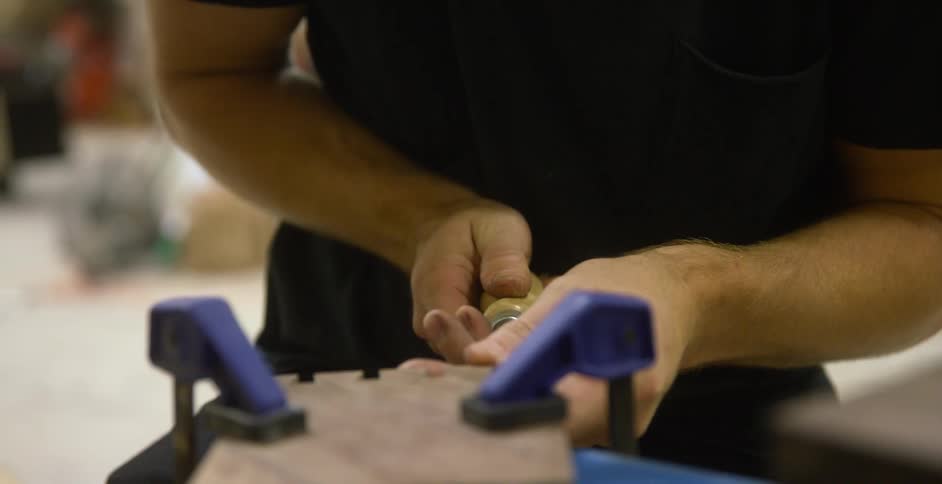 Closeup of hands chiseling wood
