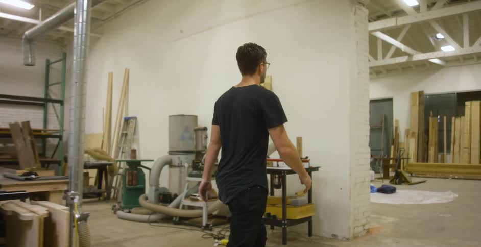 Craftsman walking through a woodshop