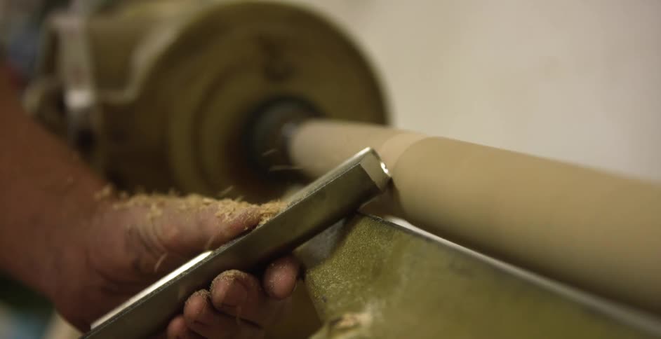 A person working on a lathe