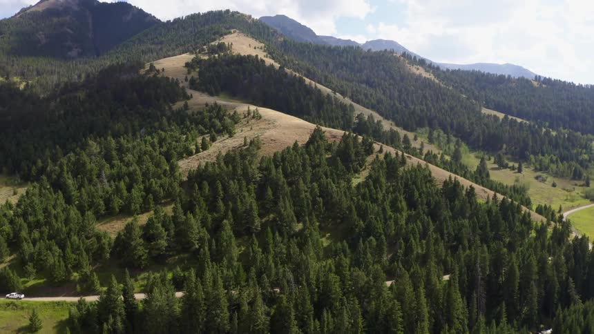 Mountains covered with forests under a cloudy sky