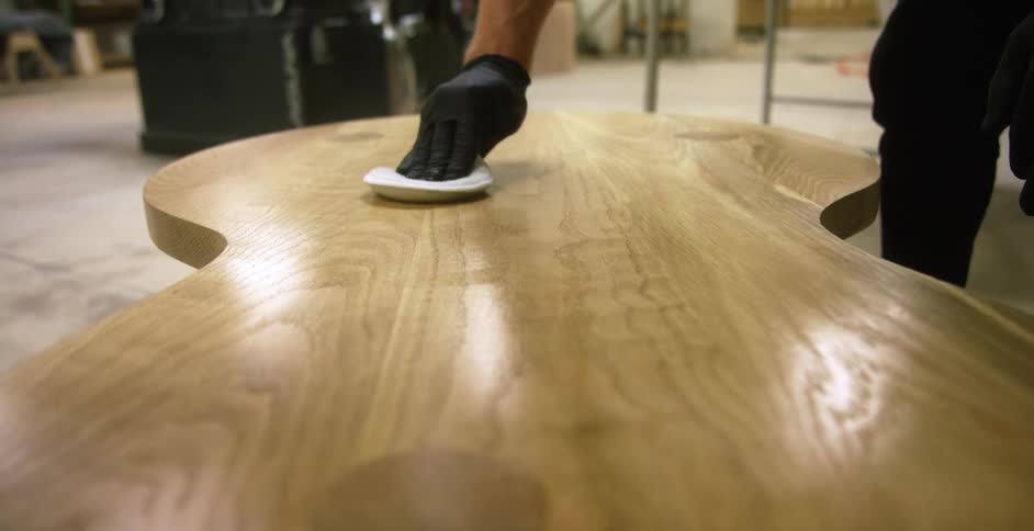 Craftsman polishing a wooden table