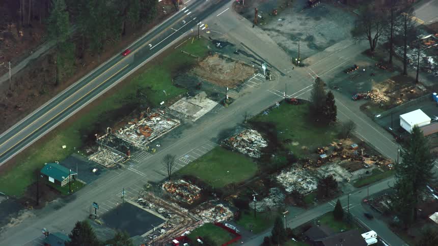 Aerial view of burned houses and buildings in a neighborhood after a wildfire swept through the town and burned down the entire neighborhood
