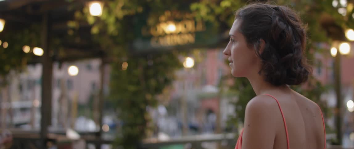 A woman walks in the evening