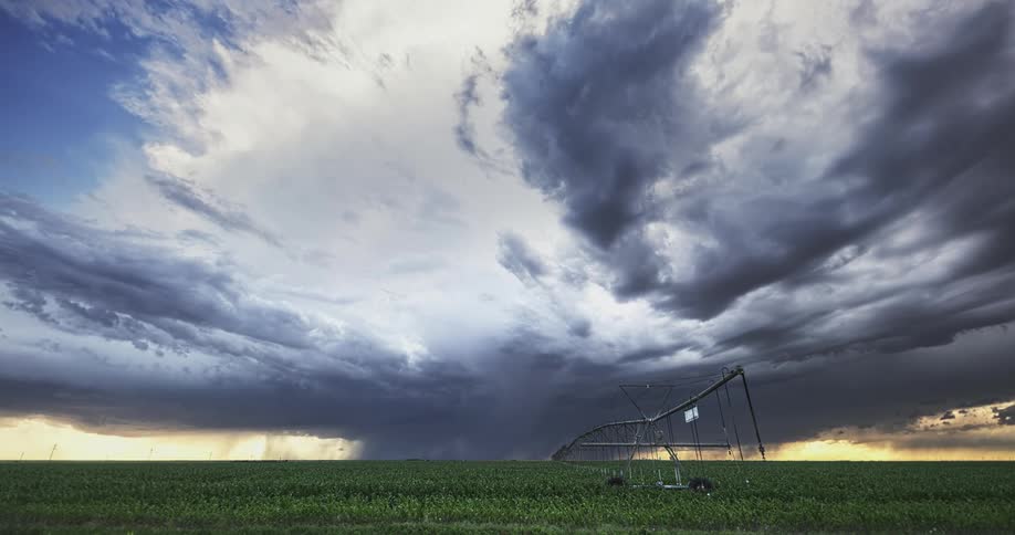 Dark storm clouds move over farm land