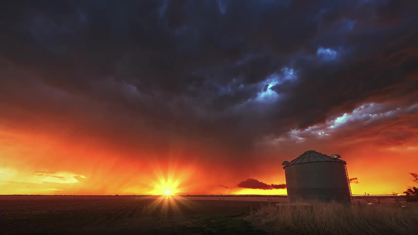 Lightning and storm clouds moving over a rural area