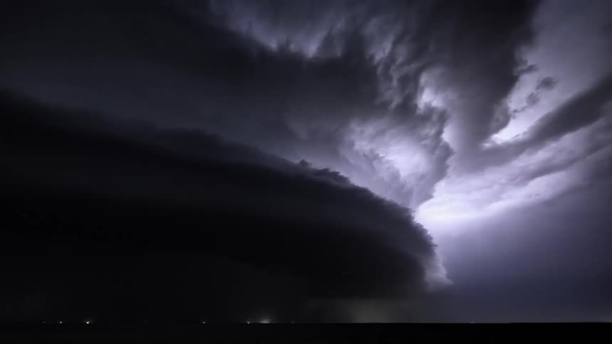 Lightning flashing in a dark night sky during a rainstorm