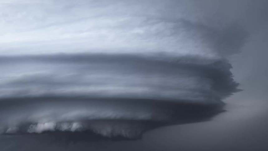 Lighting flashes from tornado clouds spinning in the air