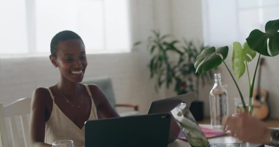 Coworkers excitedly celebrate good news while working at the office