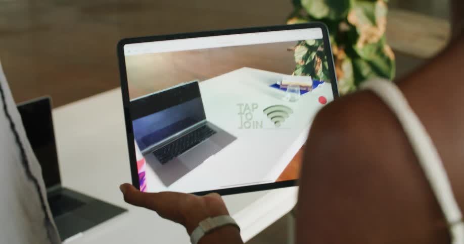 A man and woman are looking at a tablet display