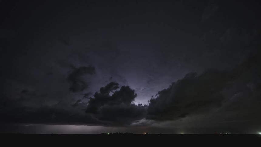 A landscape with a lightning storm with the sky and clouds above