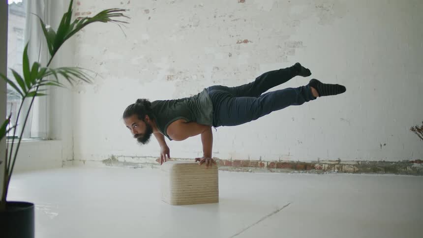 A man is doing gymnastics in his home