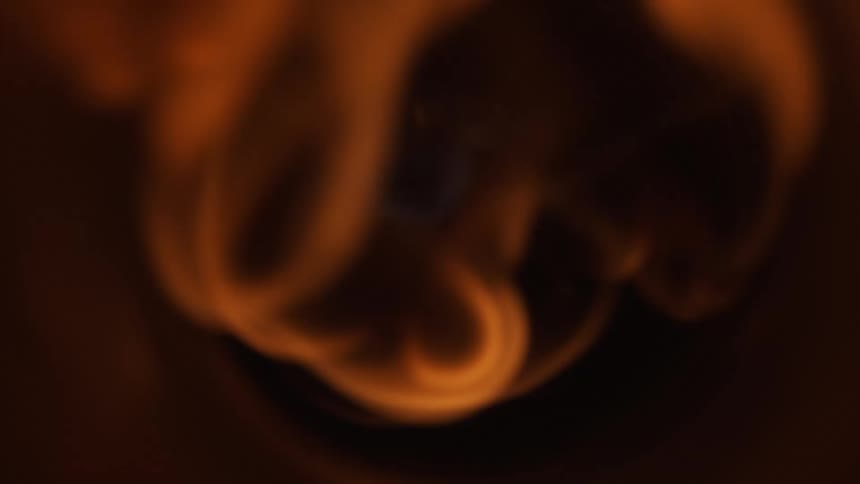 A flame moving through a tube tunnel towards camera