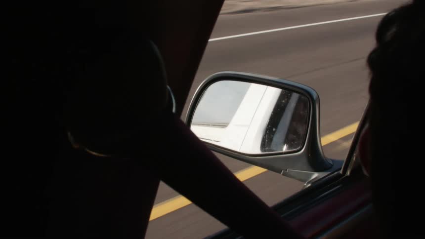 Person drives car alone asphalt road with yellow lane marker