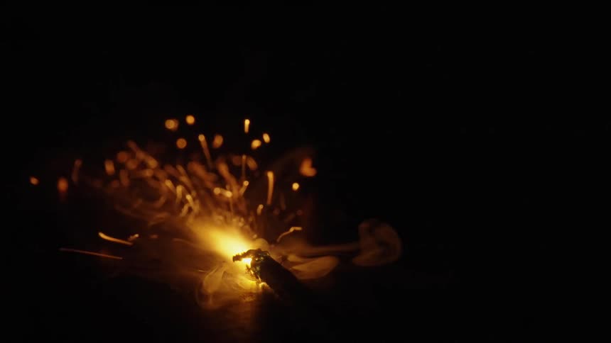 a fuse is burning with sparks in the dark