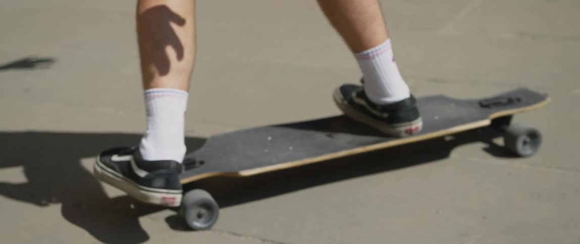 A person wearing shorts doing a trick on a skateboard