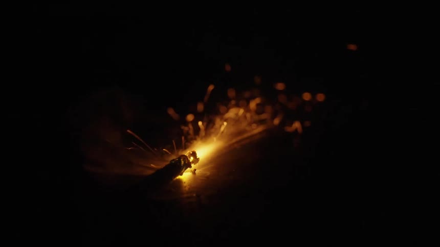 an ignited fuse burns down while the camera tracks with it