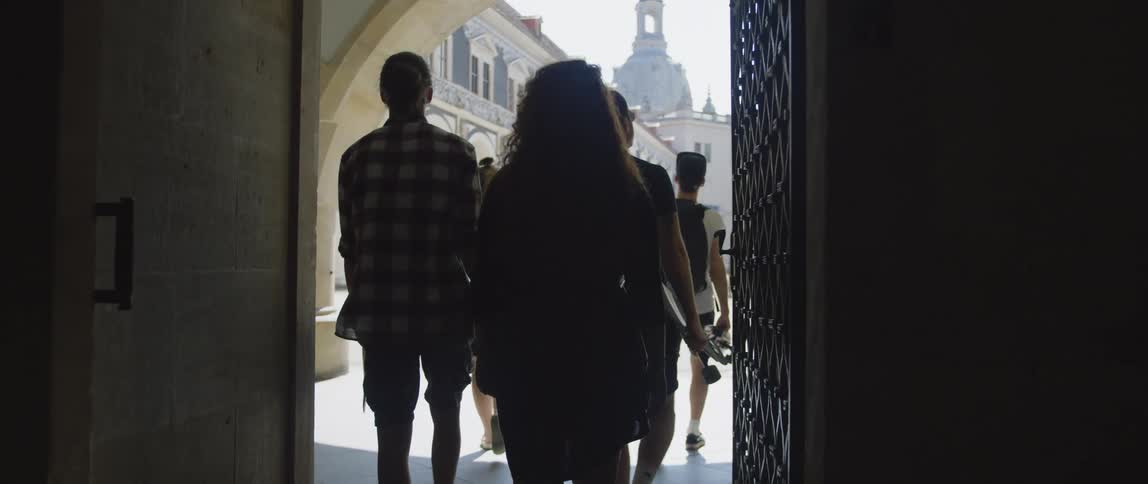 A group of friends are walking out of a building