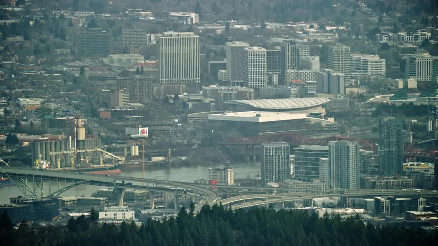 The Fremont Bridge across the Willamette River in Portland in the U.S. state of Oregon with the north hills trees in the foreground