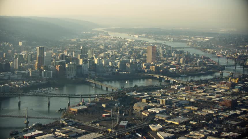 Super wide aerial of the Marquam Bridge, Hawthorne Bridge, Burnside Bridge, Morrison Bridge and Steel Bridge looking south down the Willamette River and downtown Portland Oregon on a gritty day