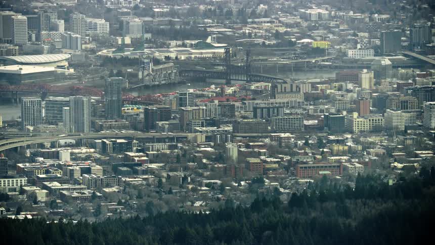 Aerial shot of downtown Portland Oregon and the steel bridge spanning the Willamette River and downtown skyscrapers