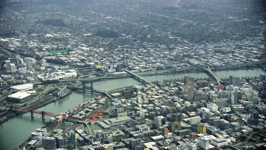 High altitude aerial of the steel bridge, burnside bridge and morrison bridge all spanning the Willamette River in downtown Portland Oregon on a gritty day