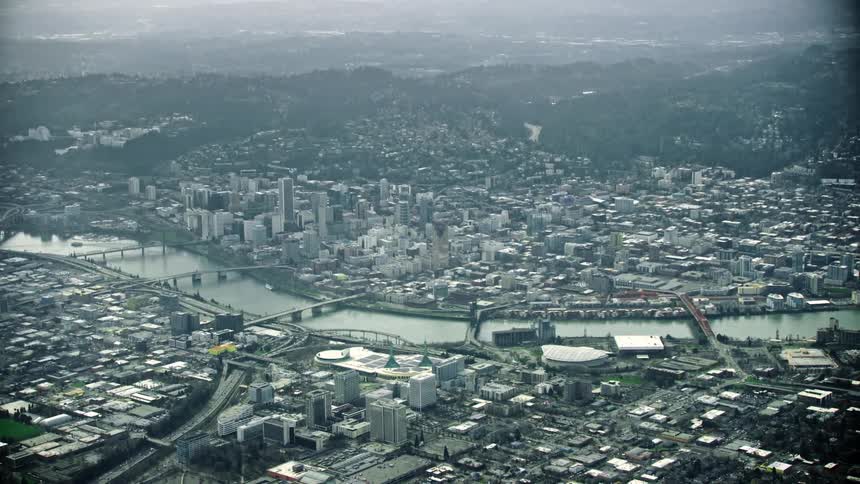 A super wide steely gray high altitude aerial of Portland Oregon on a gritty day showing the vast city and the Willamette River running through it