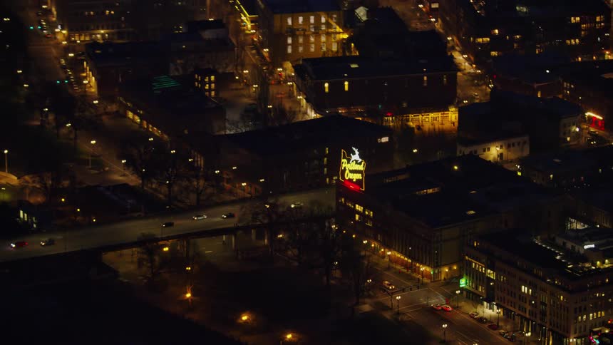 Zoom out reveal of the Portland Oregon White Stag Neon Sign as seen from high above the city at night