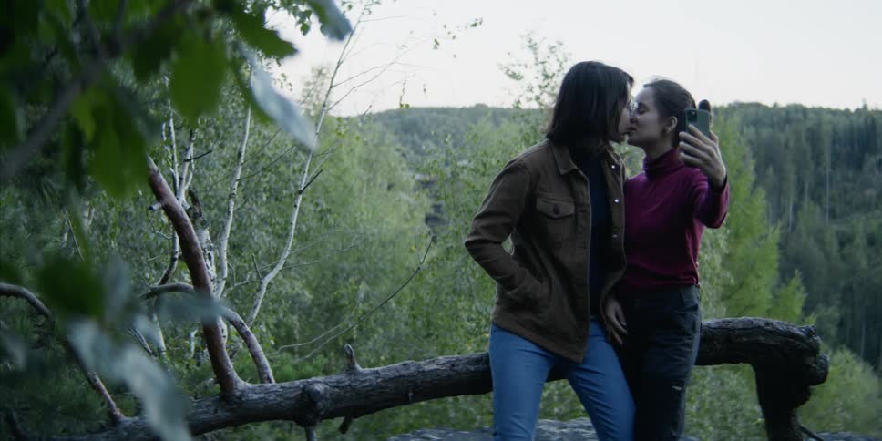 A couple kiss on the mountain top