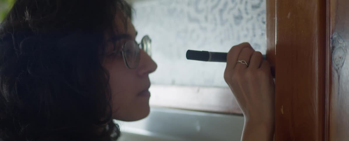 A person writes on a wall with a felt