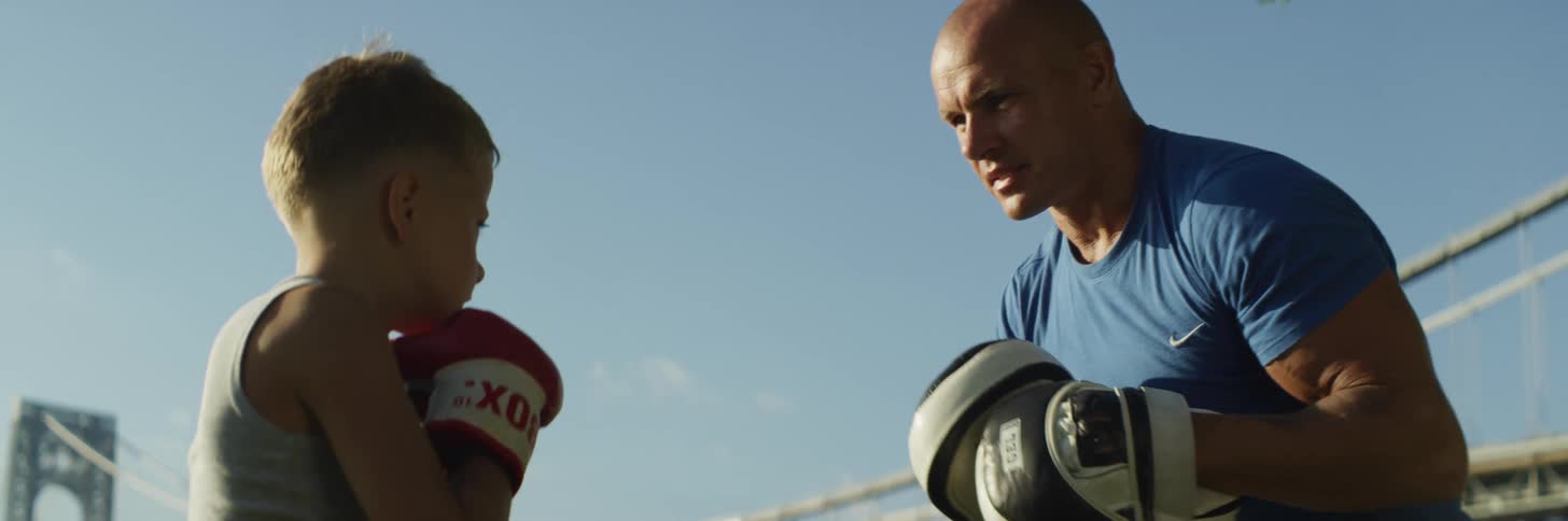 A father and son boxing outdoors