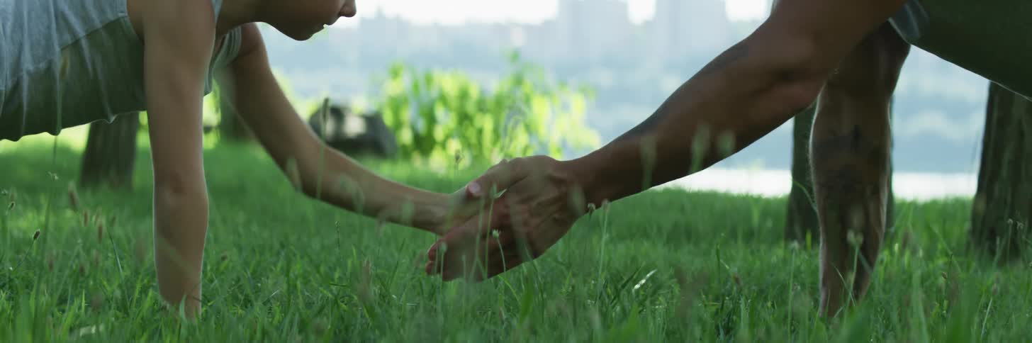 A man and boy do pushups on the lawn